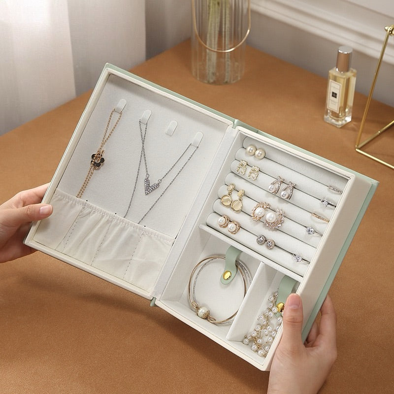 Creative book-style jewelry box for storing rings, necklaces, earrings, and studs; portable and large-capacity jewelry organizer