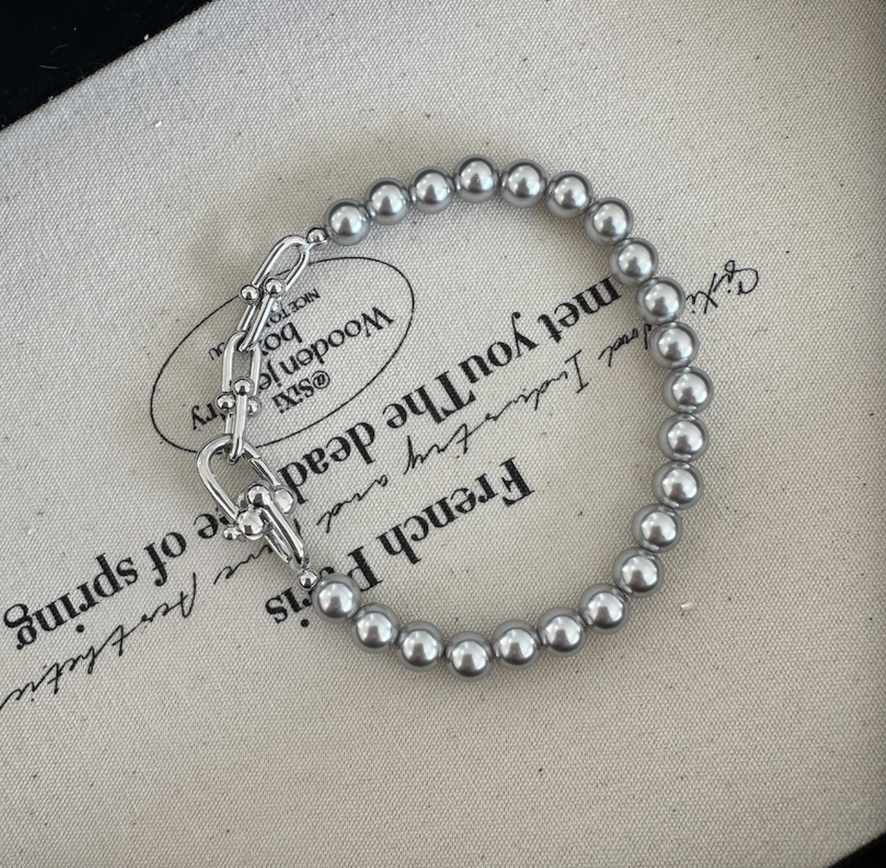 Grey faux pearl panelled horseshoe clasp bracelet