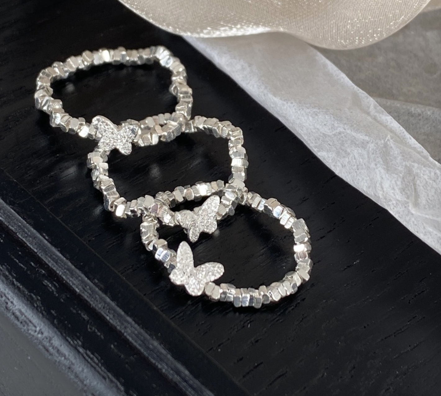 An all-over 925 silver crushed silver small butterfly ring
