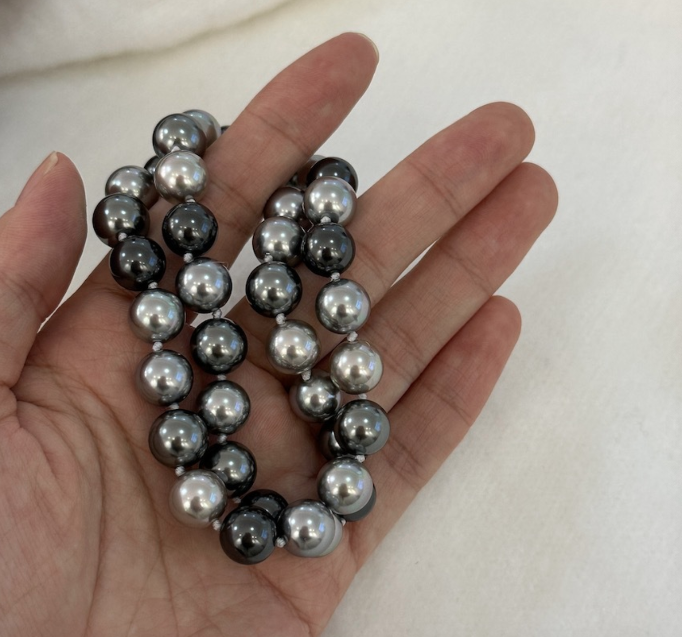 Necklace of faux melange gray-green pearls