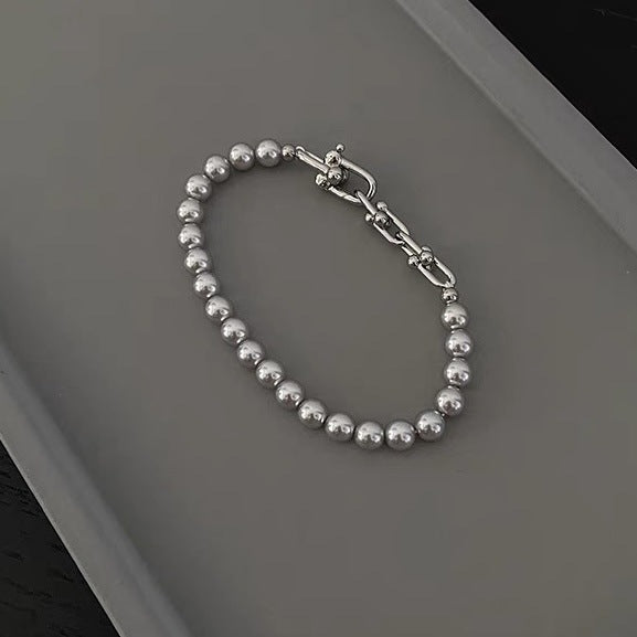 Grey faux pearl panelled horseshoe clasp bracelet