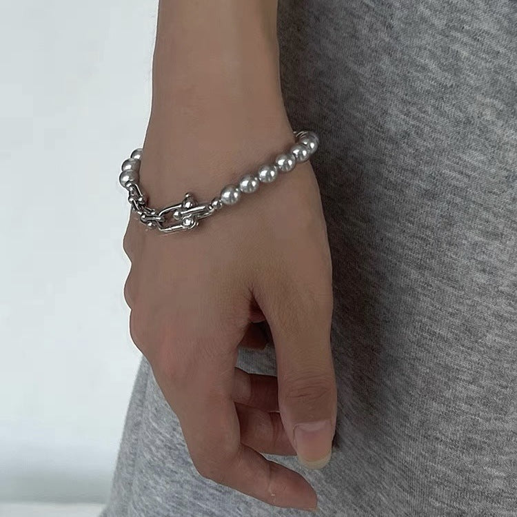 Grey faux pearl panelled horseshoe clasp bracelet